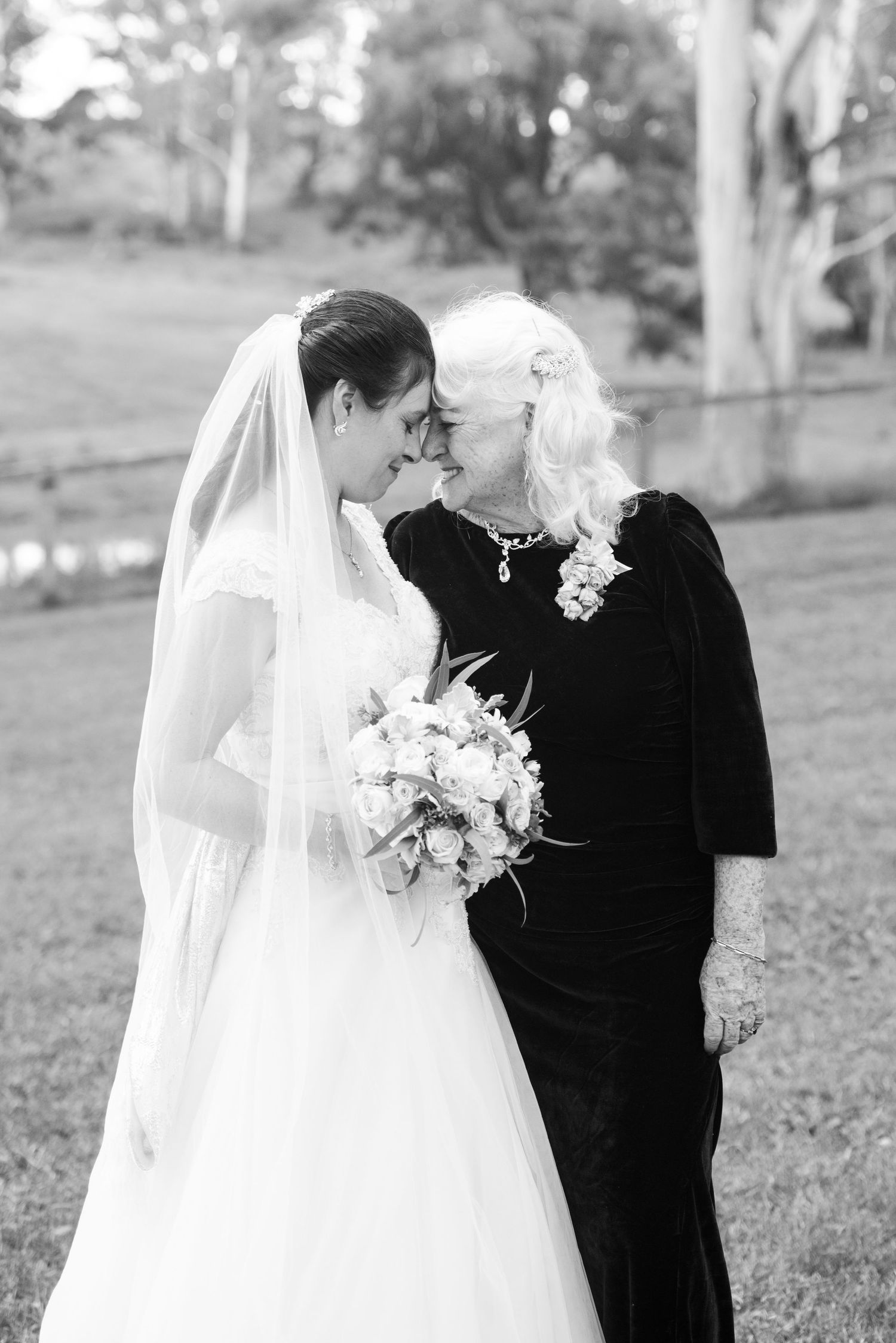Black and white wedding photo series showing tender moments between a daughter and mother.