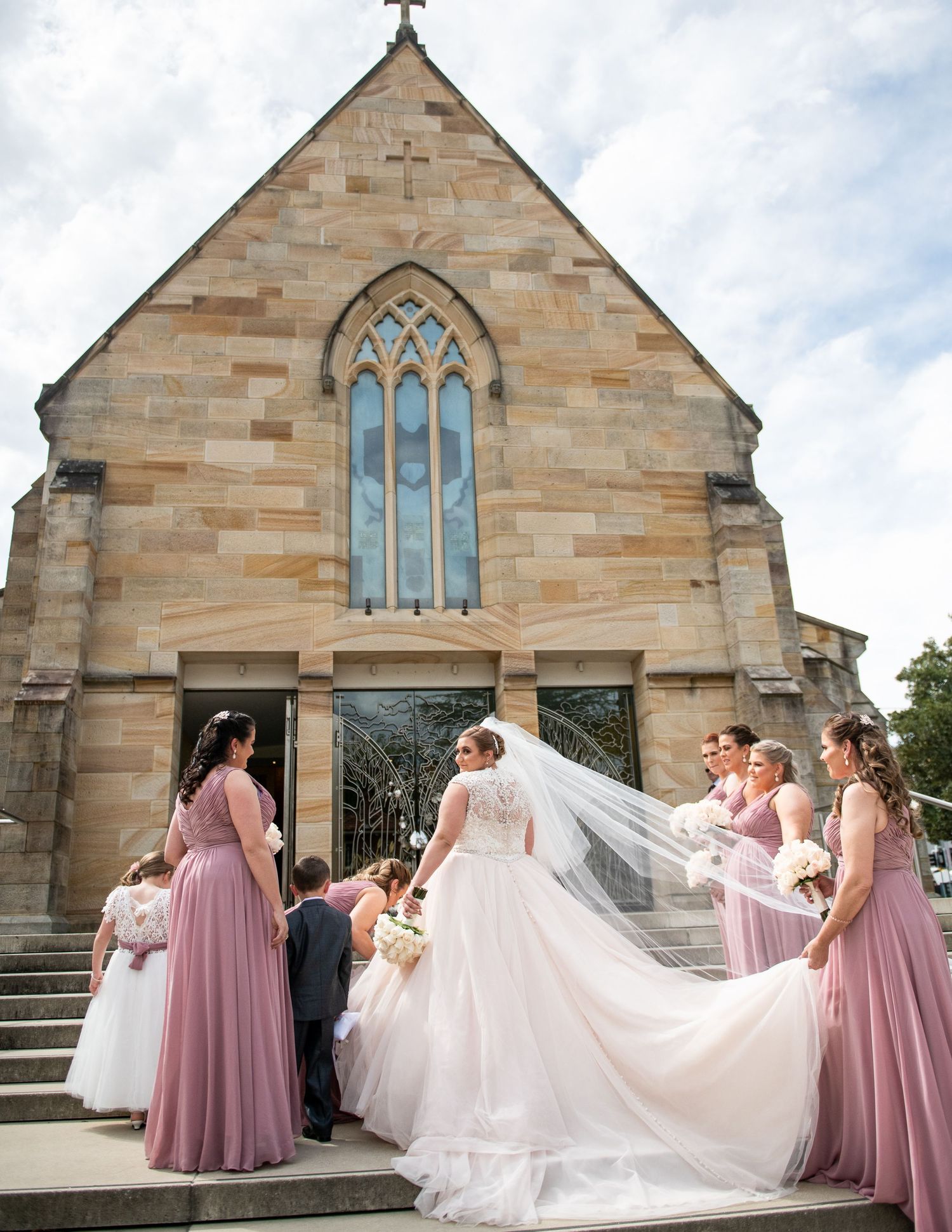 Bride before entering Church with her bridesmaids.