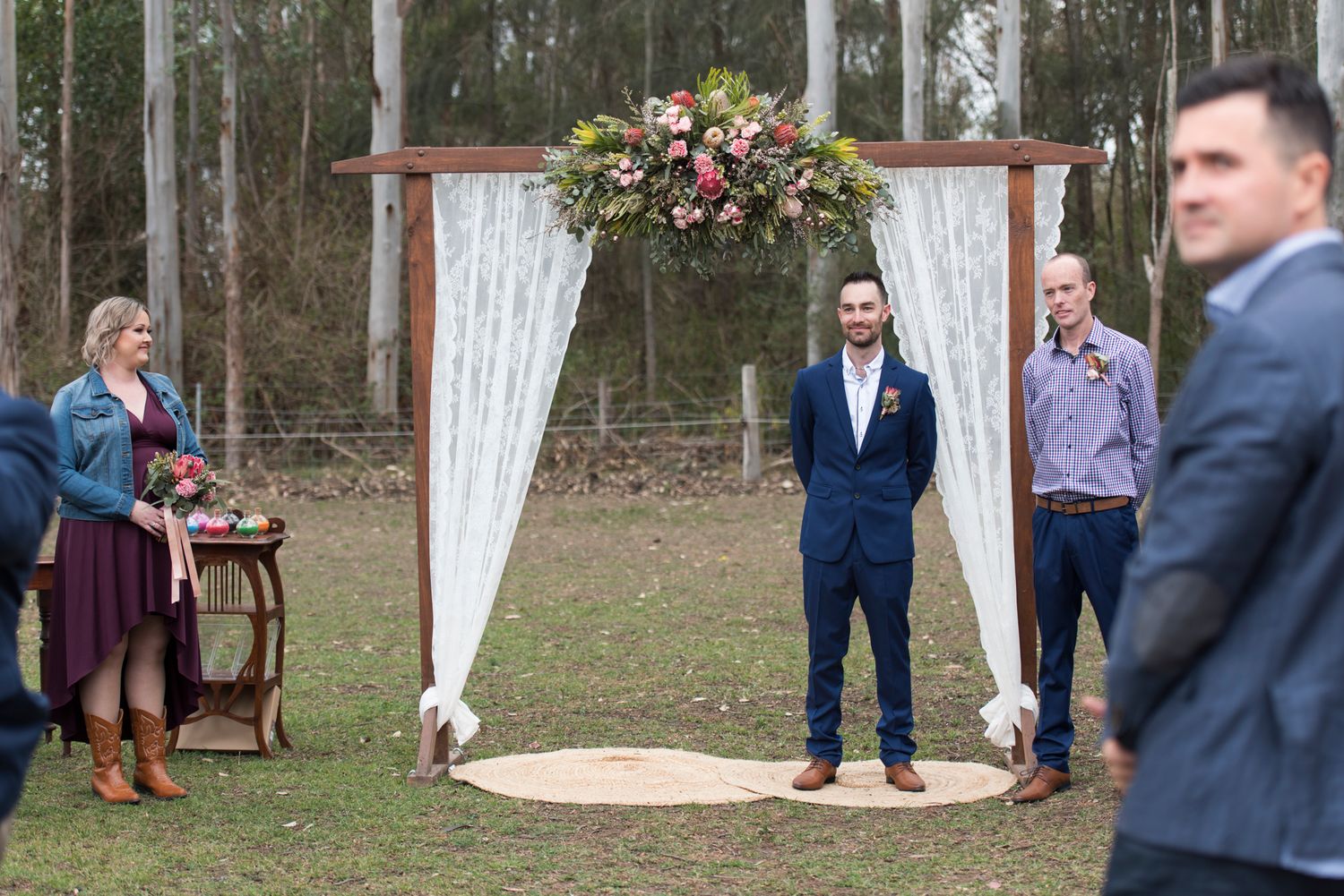 Groom waiting for the bride in a country setting during a rustic celebration.