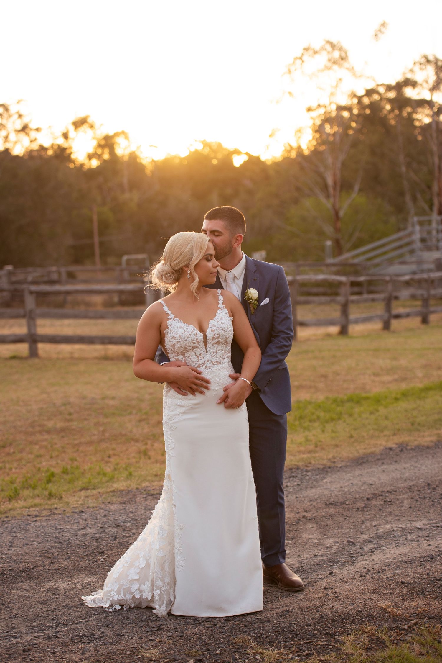Romantic sunset wedding photo series showing couple embracing on a rustic country path at golden hour.