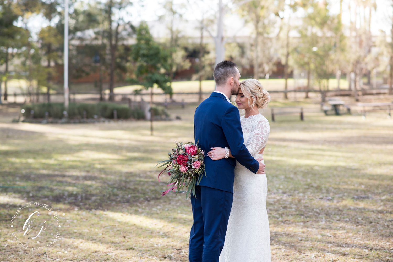 Bride and groom embrace.