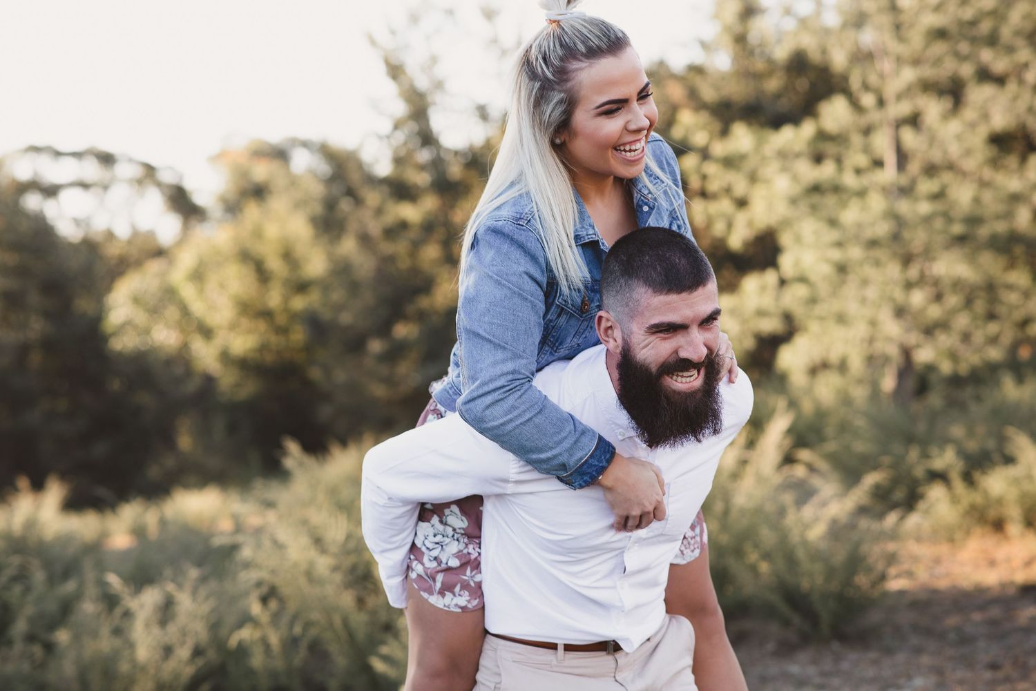 A playful piggyback ride moment captured in golden hour lighting.