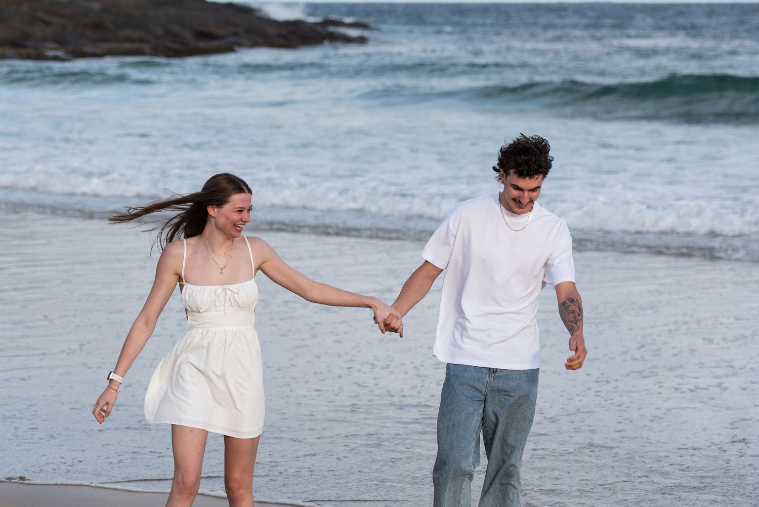 Couple walking on the beach during their photo session in Kiama.