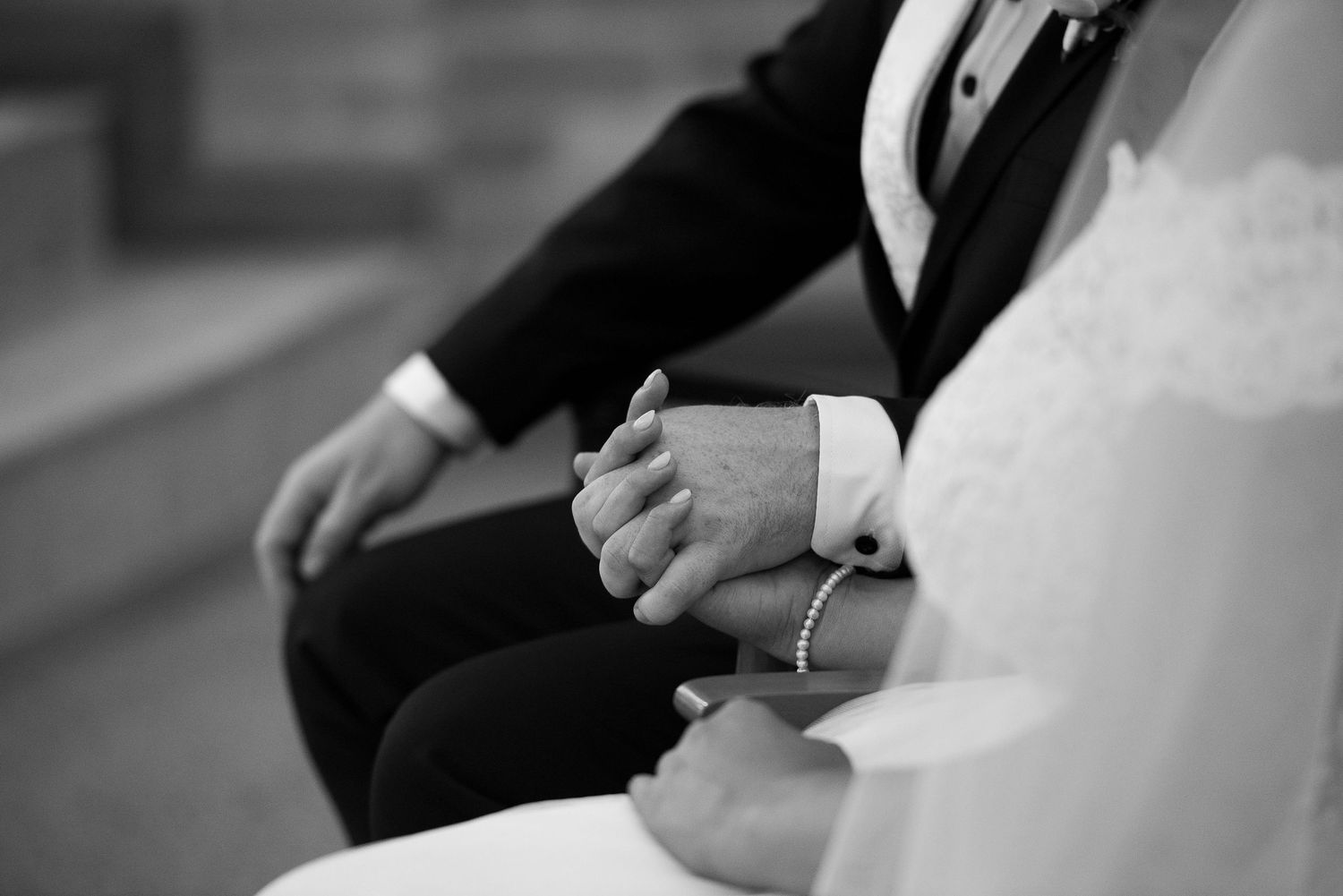 A black and white photo series showing hands during wedding ceremony.