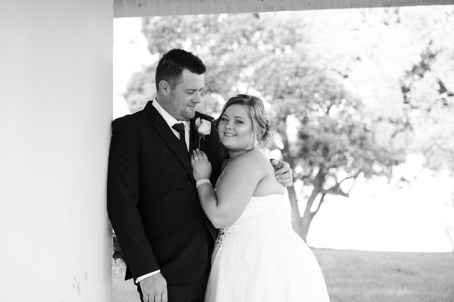 A romantic black and white wedding photo collection showing tender moments between a couple in formal attire.