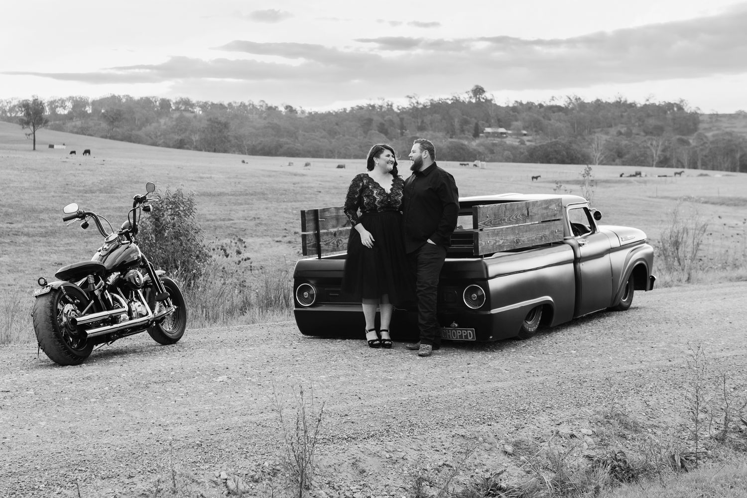 A series of vintage black and white photographs showing classic cars and motorcycles parked in rural settings.