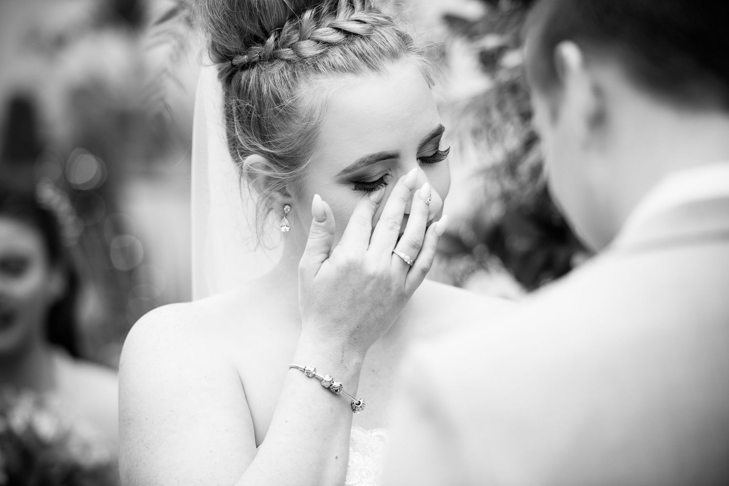 A black and white collage of wedding moments showing emotional reactions and intimate gestures during the celebration.