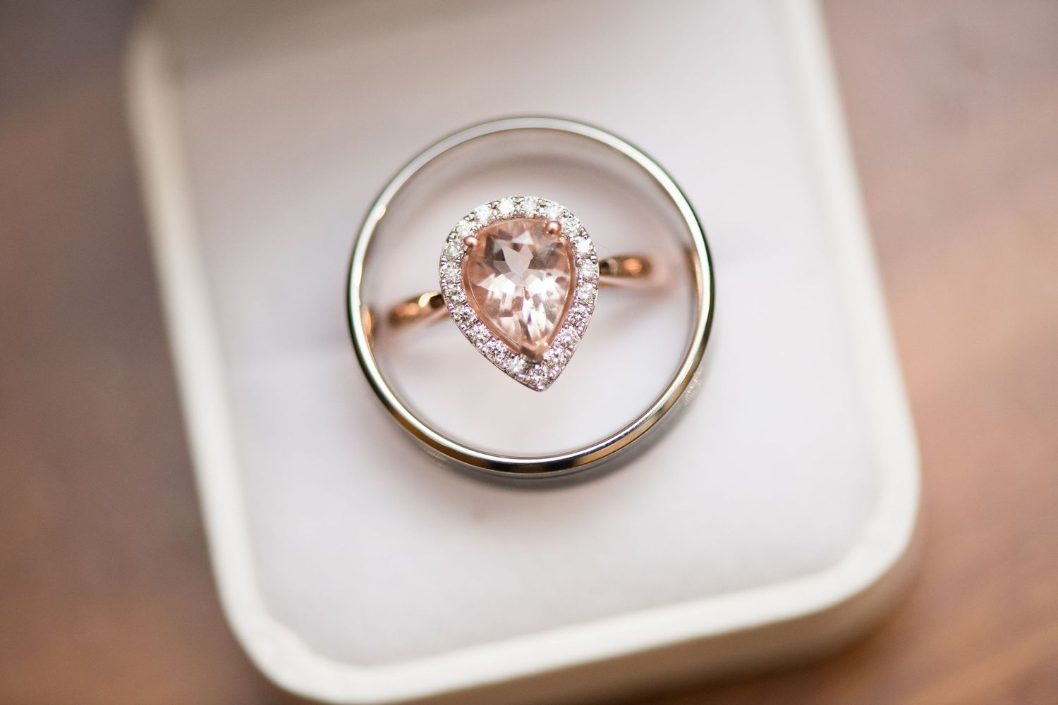 Engagement ring and wedding band displayed in white box.