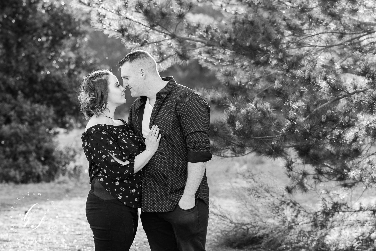A romantic black and white photo series showing tender moments in an outdoor setting.