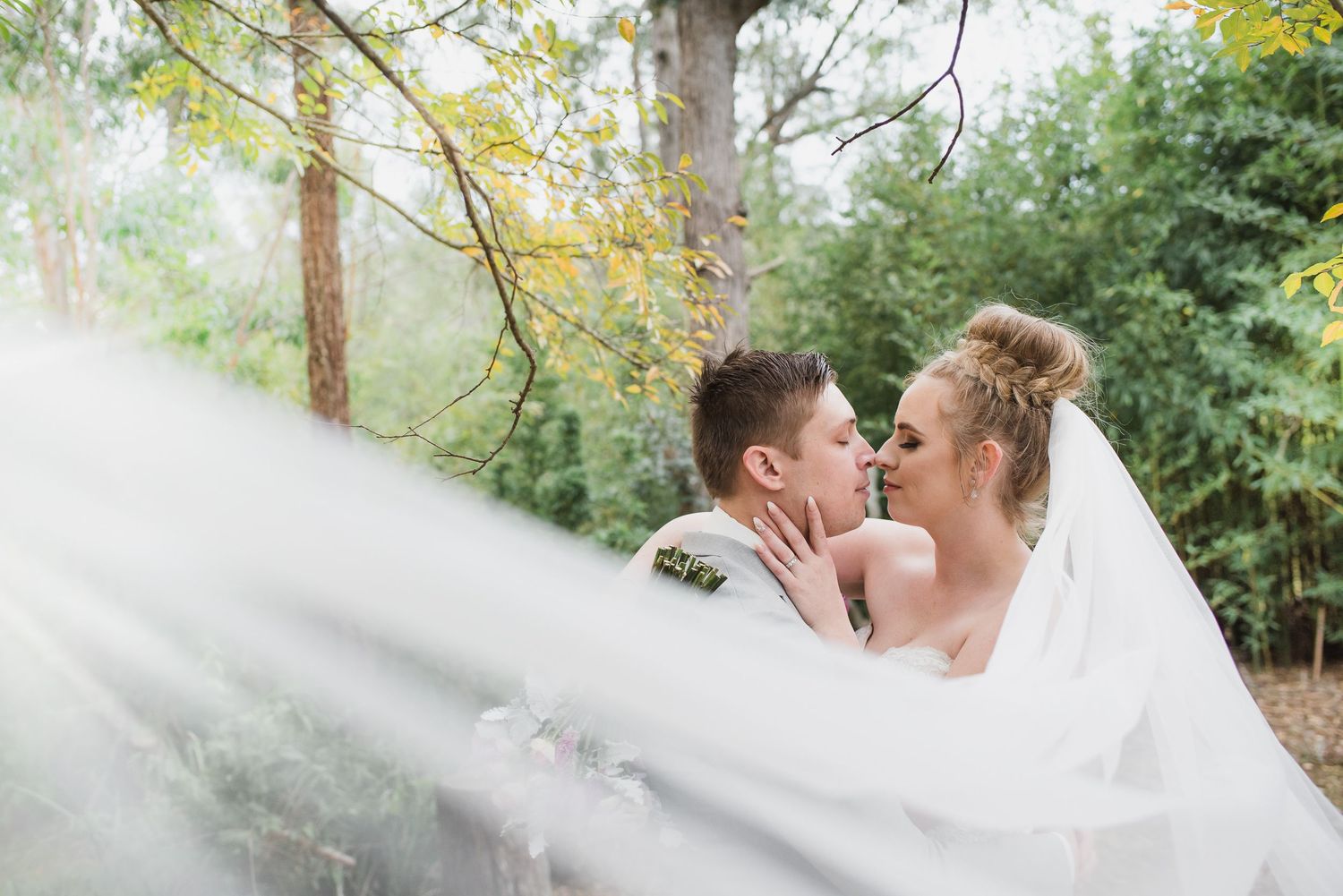 Bride and groom with long veil on wedding day in Hunter Valley