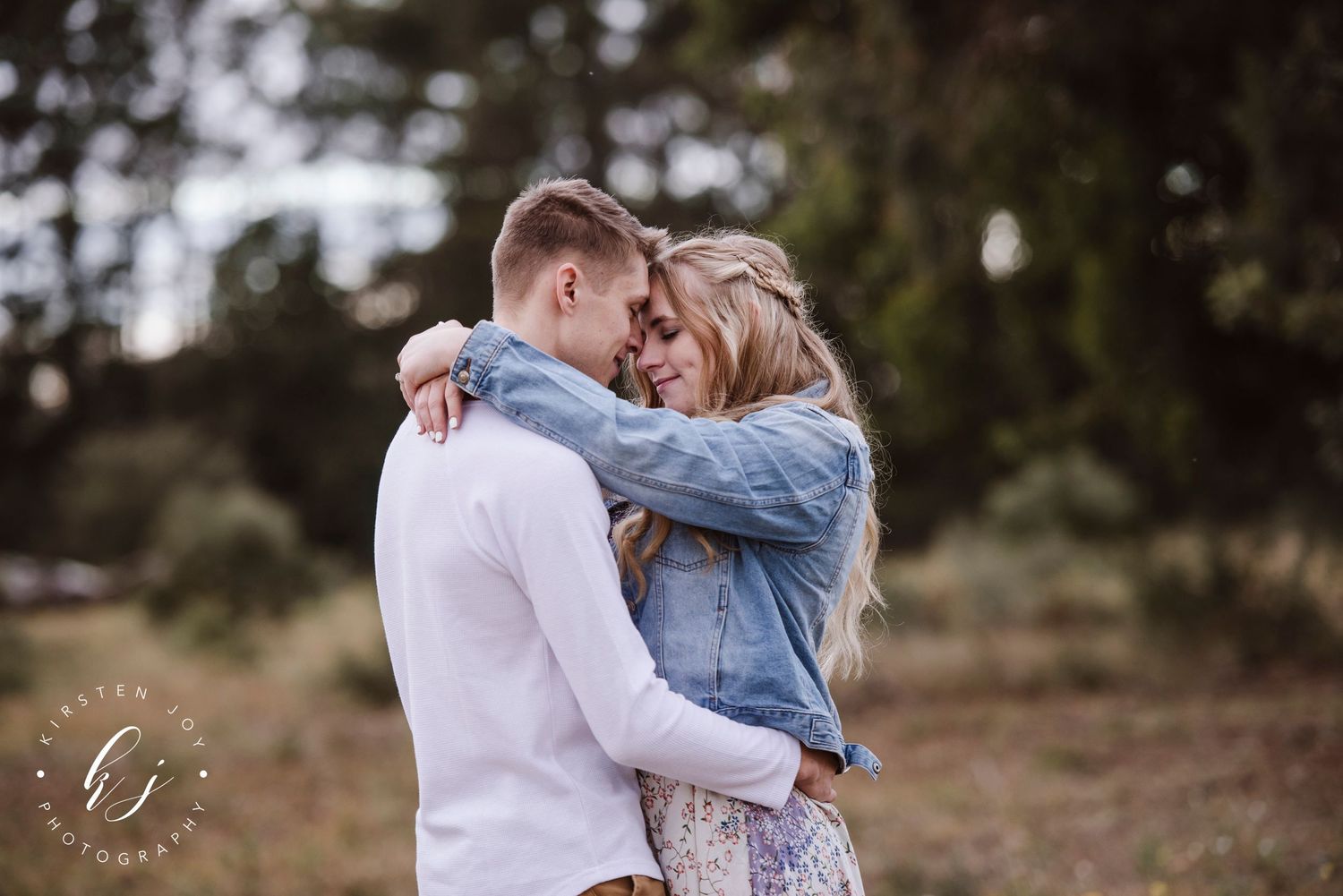 Romantic engagement photos captured in a natural outdoor setting.