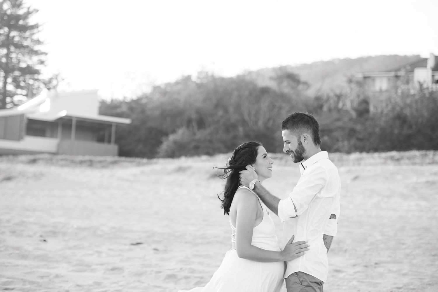 Black and white wedding portraits showing romantic moments in outdoor natural setting.