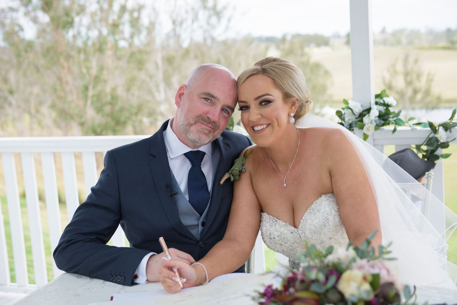 Romantic wedding couple shares intimate moments after signing official wedding documents.