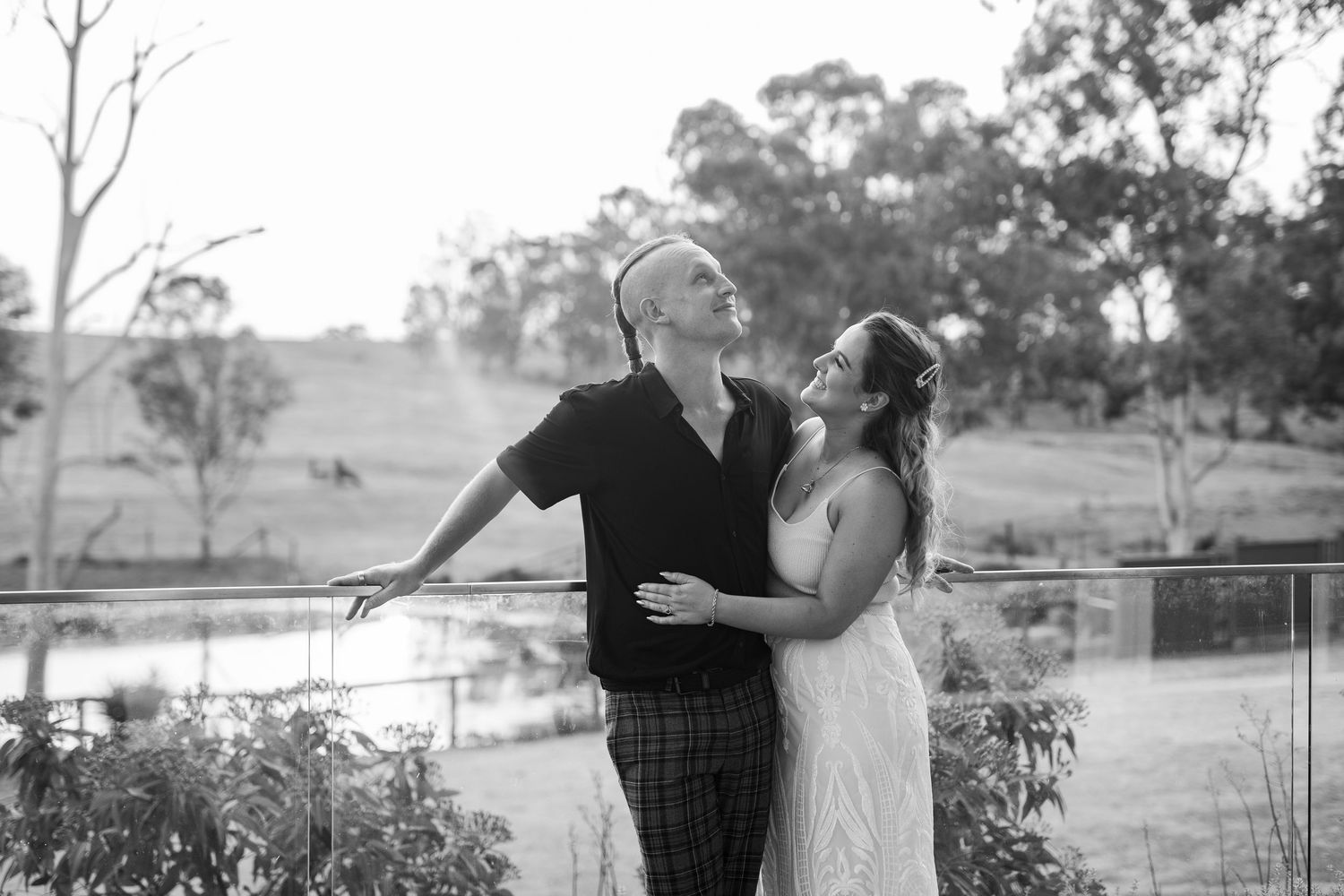 A romantic black and white wedding photo collage showing couples embracing in outdoor garden settings.