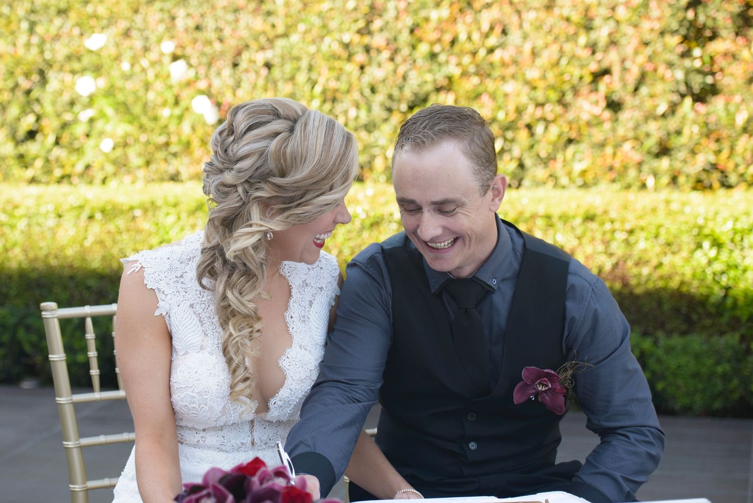Couple sharing a joyful moment together after signing their wedding documents.