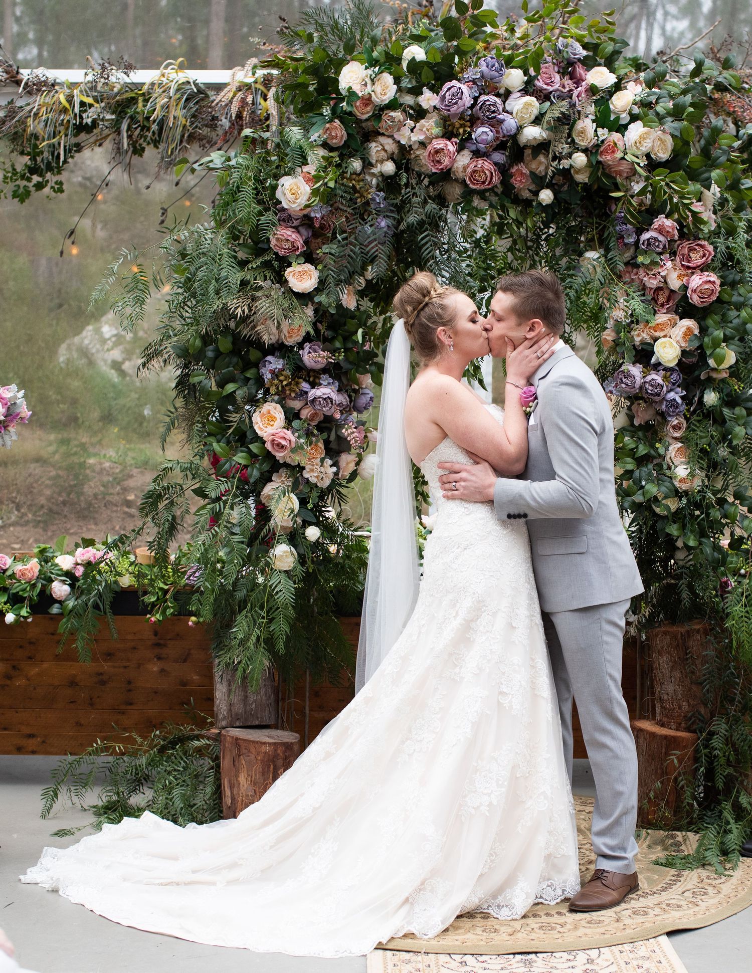Bride and groom sharing their first kiss.