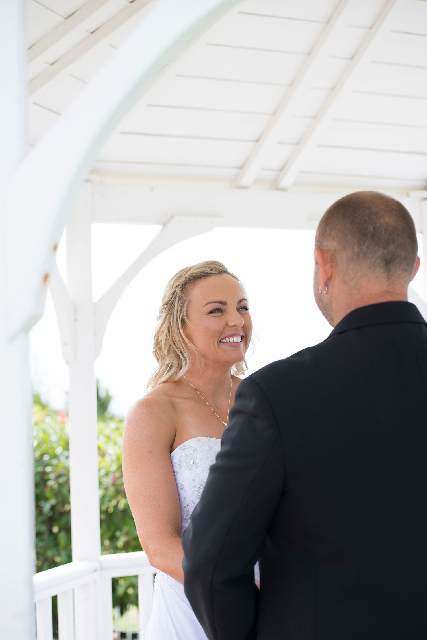 Bride and groom under gazebo during wedding ceremony at Panorama House.