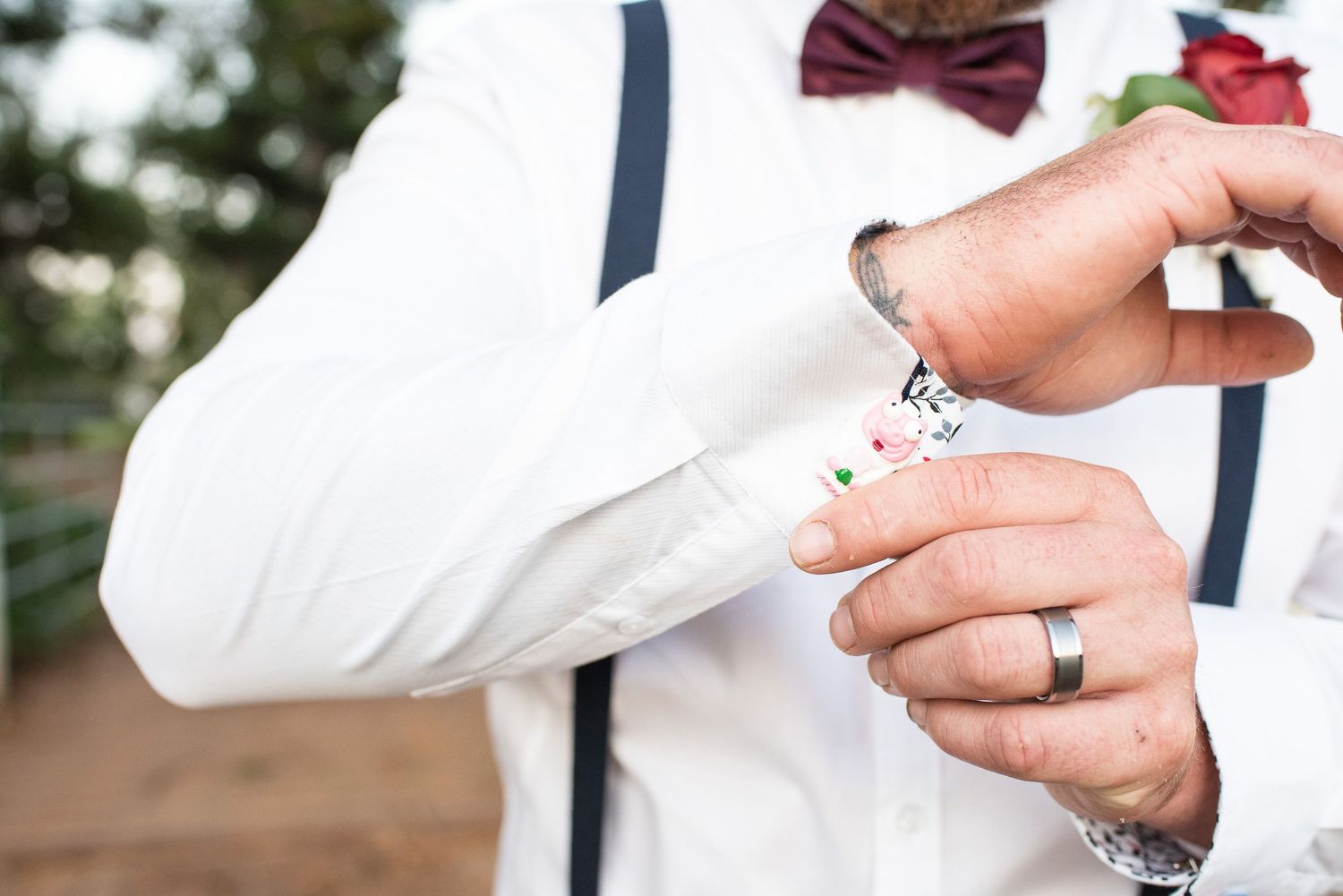 Close-up view of grooms cuff links.