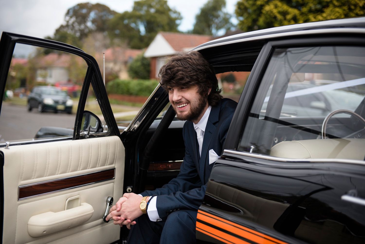 A candid moment captured in a vintage car with cream leather interior.