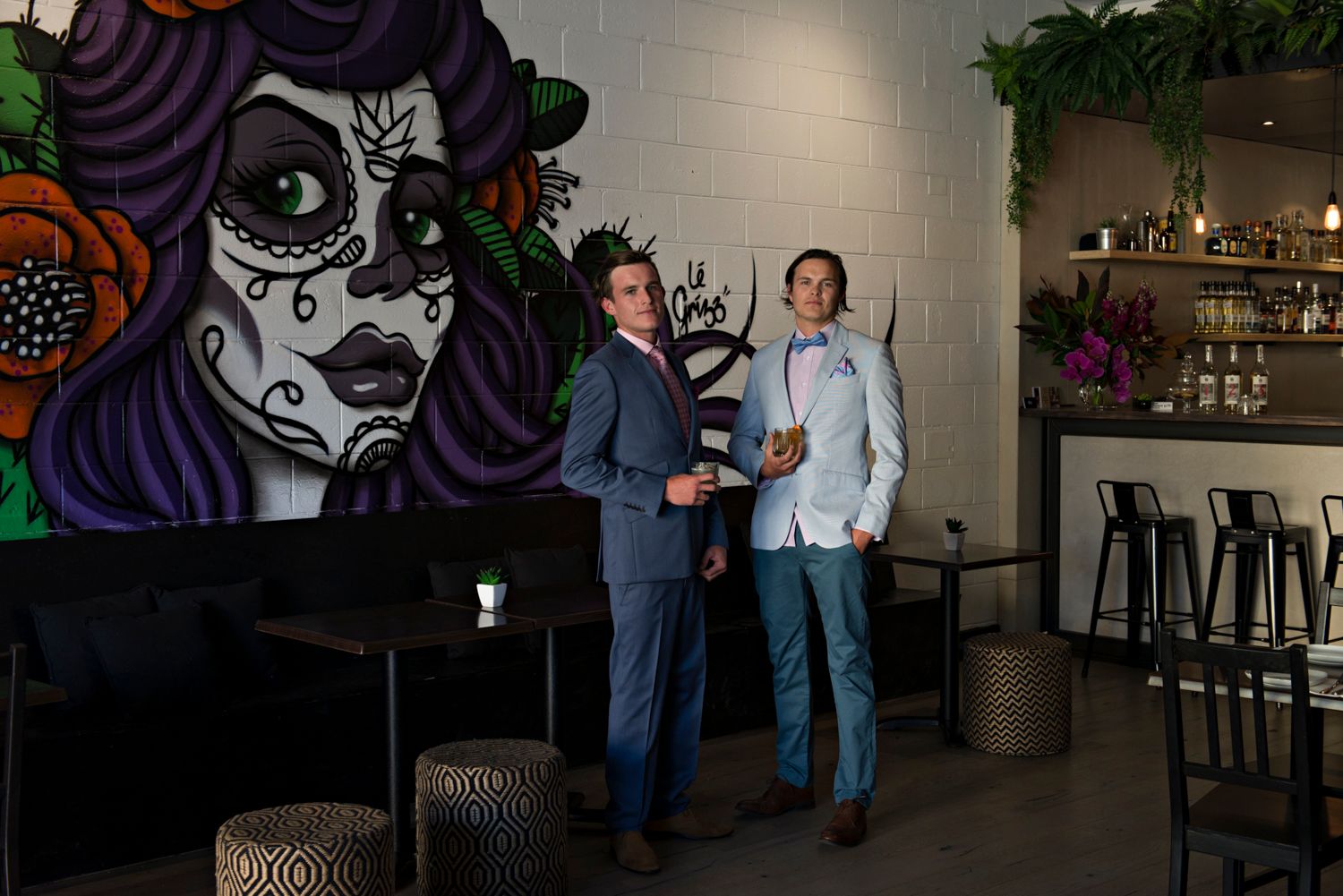 Dark restaurant interior with artistic wall murals and ambient lighting.