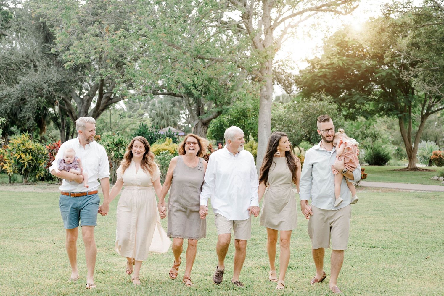 Lifestyle family portrait at Lakes Park with soft golden light.
