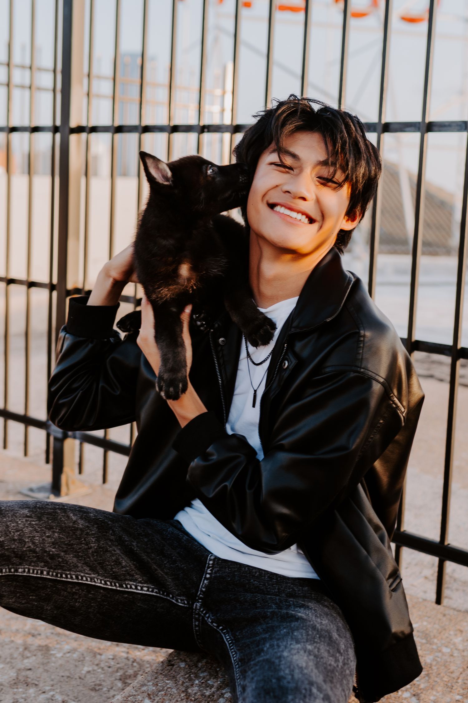 Senior portrait showcasing personal style and confidence in Oklahoma City while posing with their puppy.
