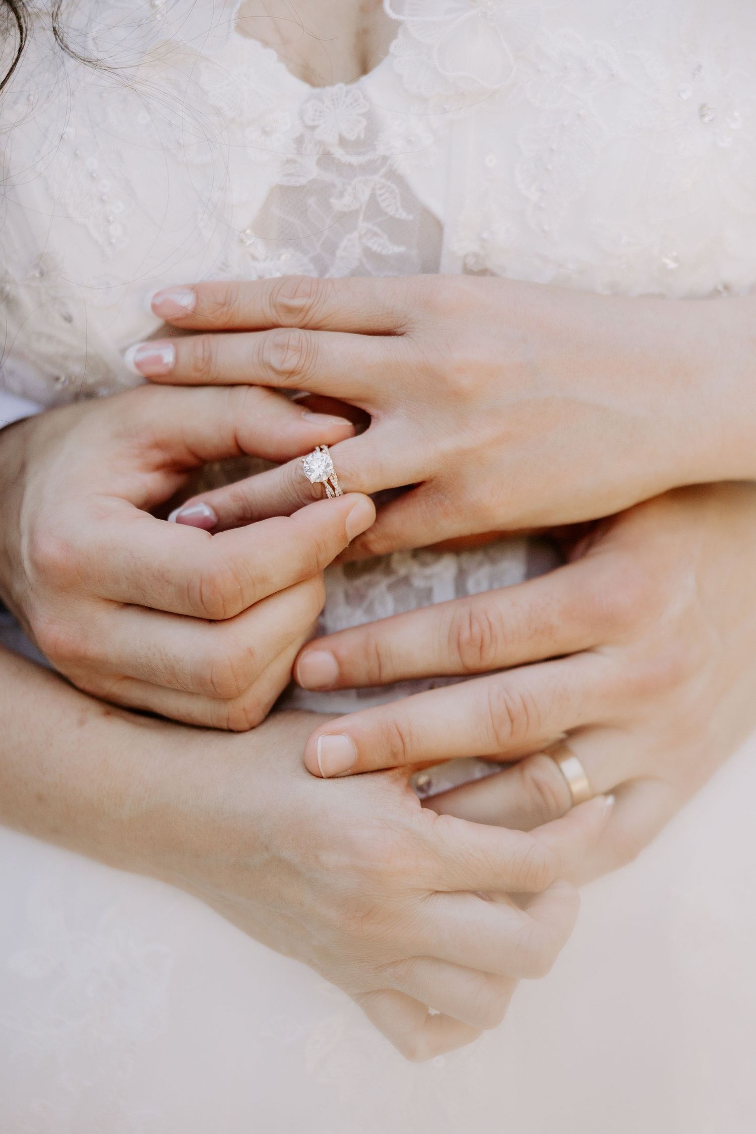 Close up portrait of a bride and groom holding their wedding rings during a wedding photography session at OKC Will Rogers Park.