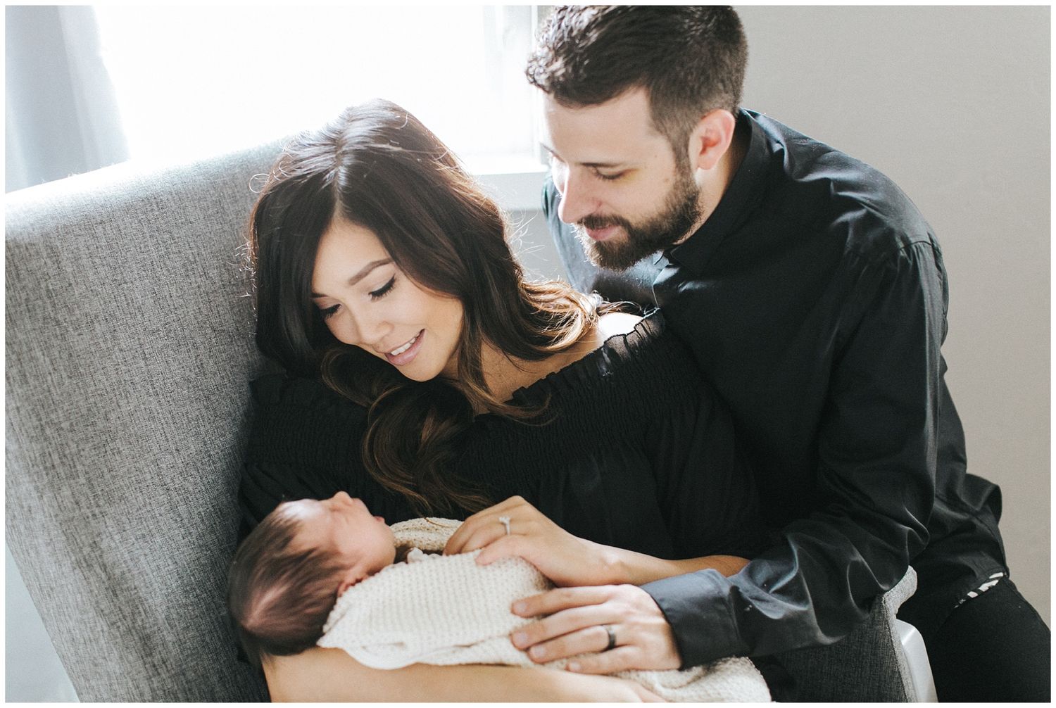New parents holding their newborn during a family photography session with Rebecca Glass Photography in Edmond, OK.