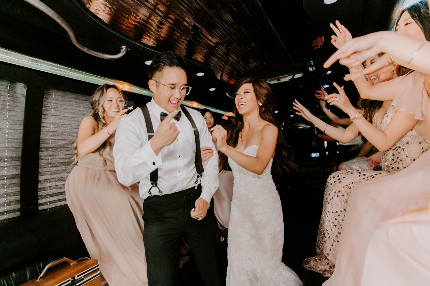 Bride and groom dancing in party bus in Oklahoma City right before their wedding reception at the Civic Center Music Hall, Hall of Mirrors.