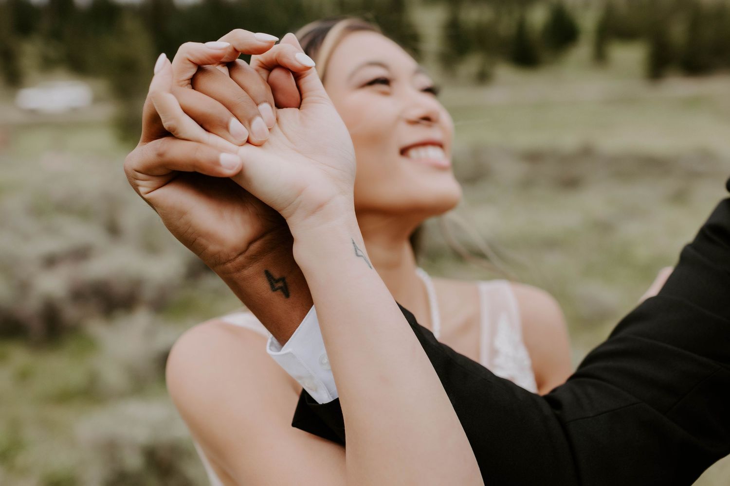Close up shot of a couple holding hands during their wedding photography session in Colorado that Rebecca Glass Photography traveled for.