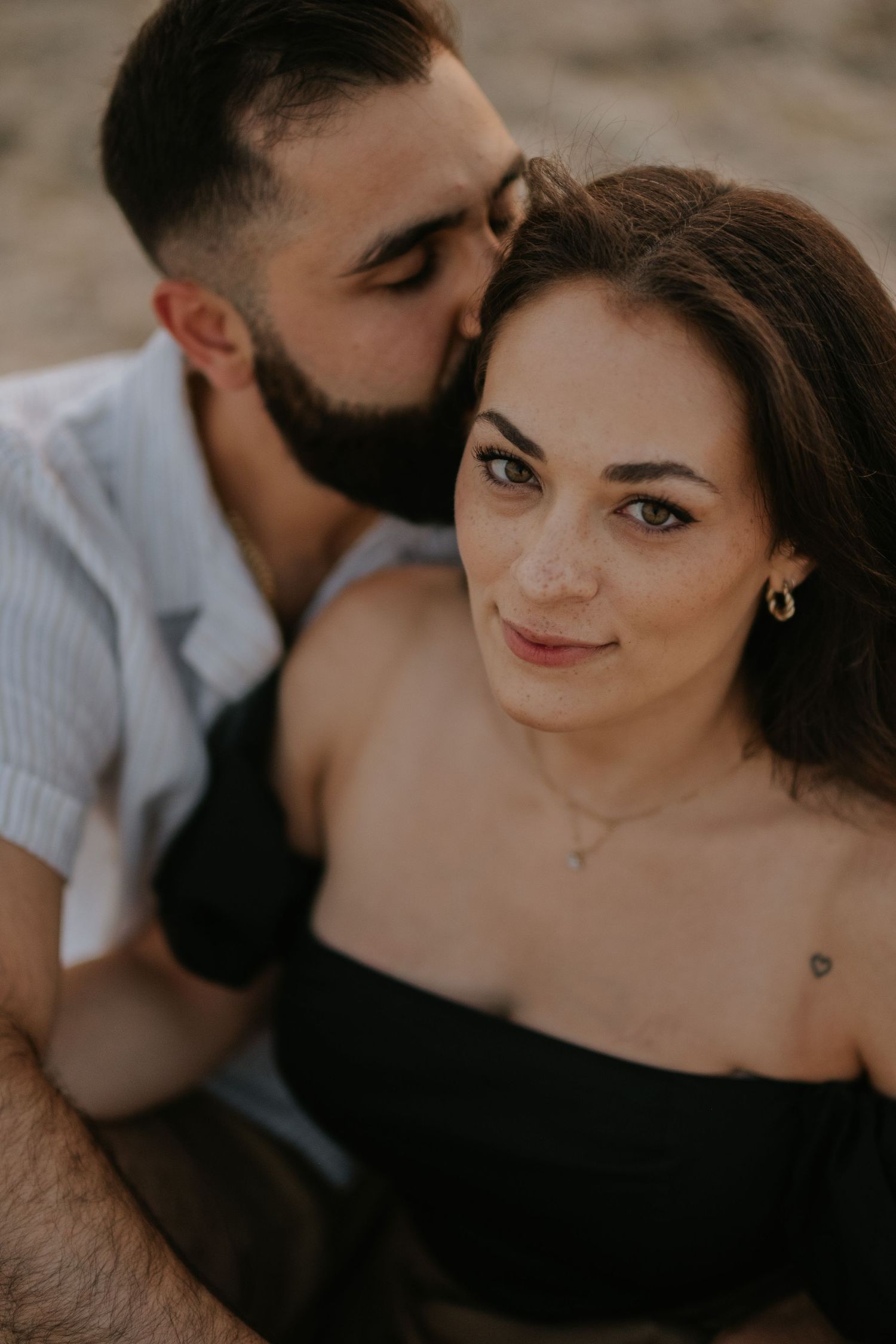 Romantic couple shares intimate moments in a series of five black and white portrait photographs.