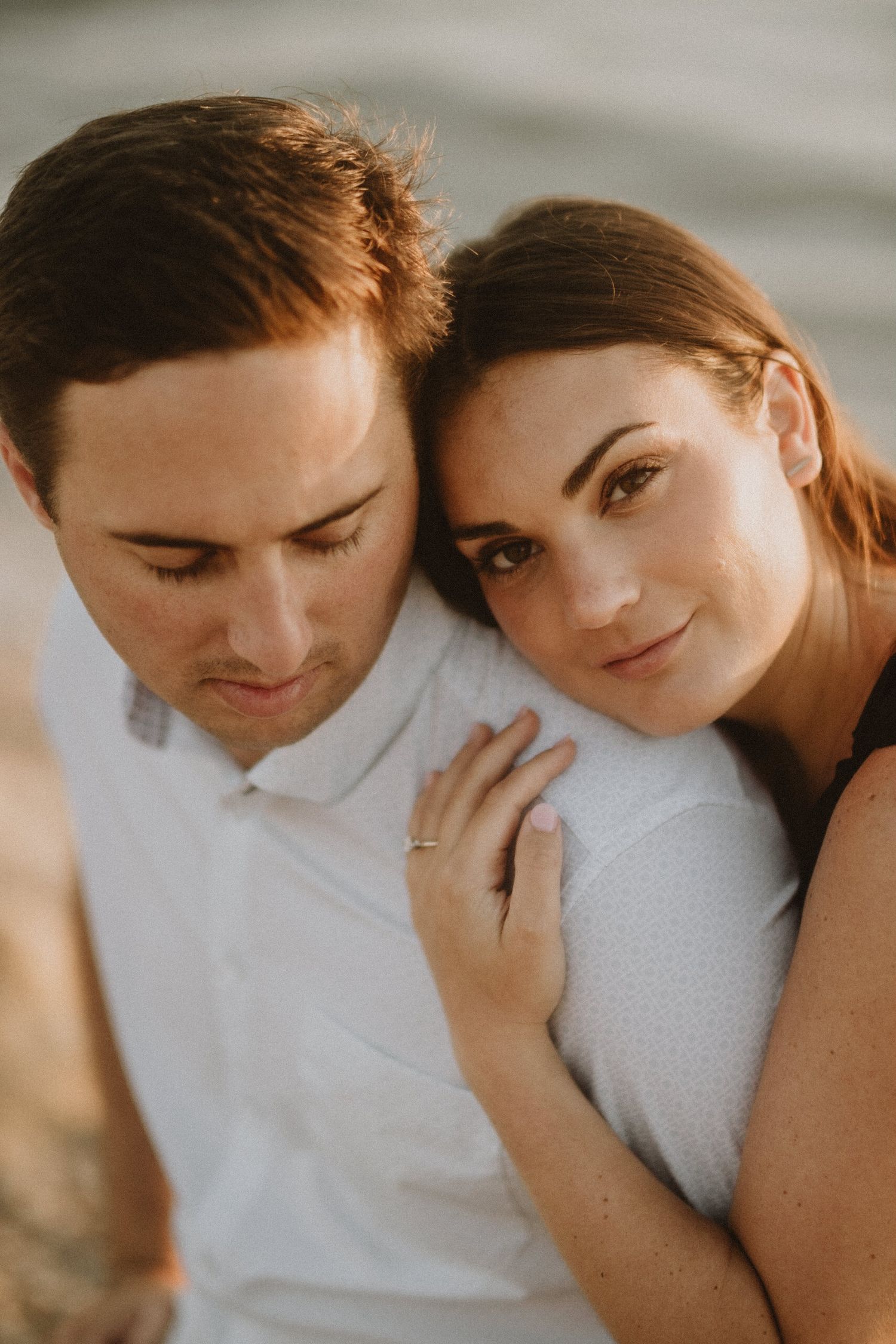 Intimate couple shares tender moments in a series of warm-toned close-up photographs.