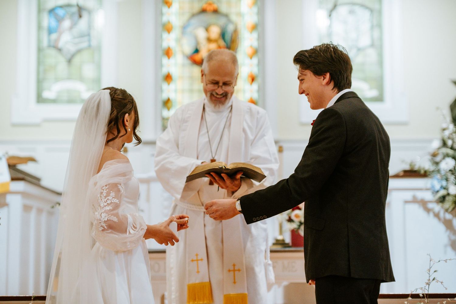 A sequence of wedding ceremony moments showing the exchange of rings and blessings in a bright church setting.