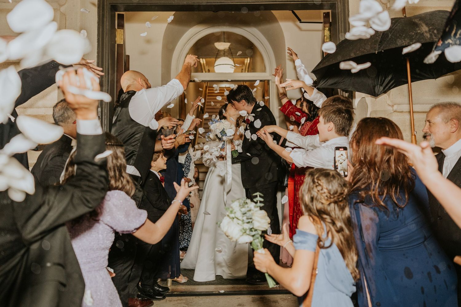 Wedding reception dance floor filled with celebrating guests in motion.