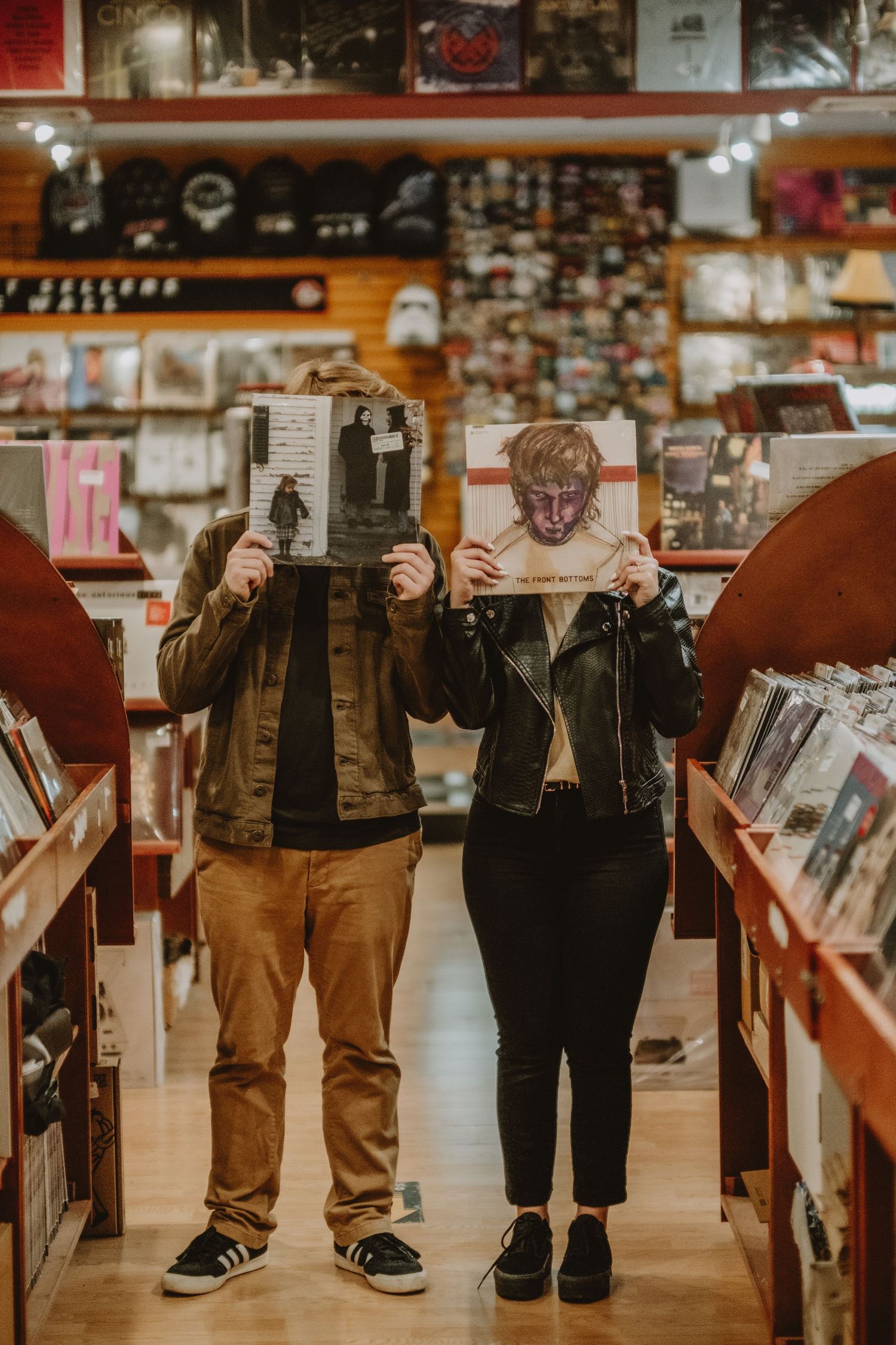 Low angle view of customers' legs browsing through aisles in a record store.