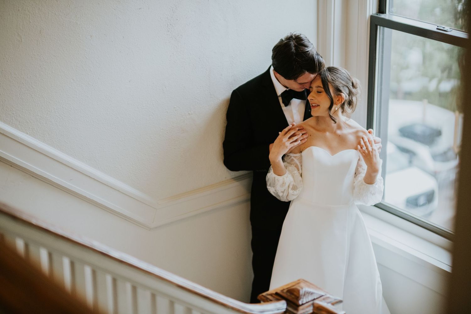 Intimate wedding portraits captured in soft window lighting.