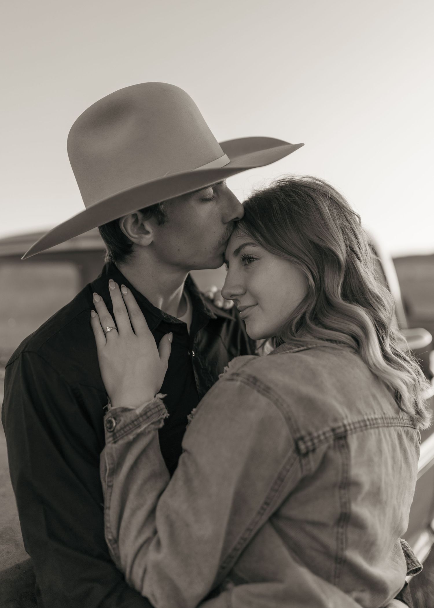 A romantic black and white photo sequence captures intimate moments between two people.