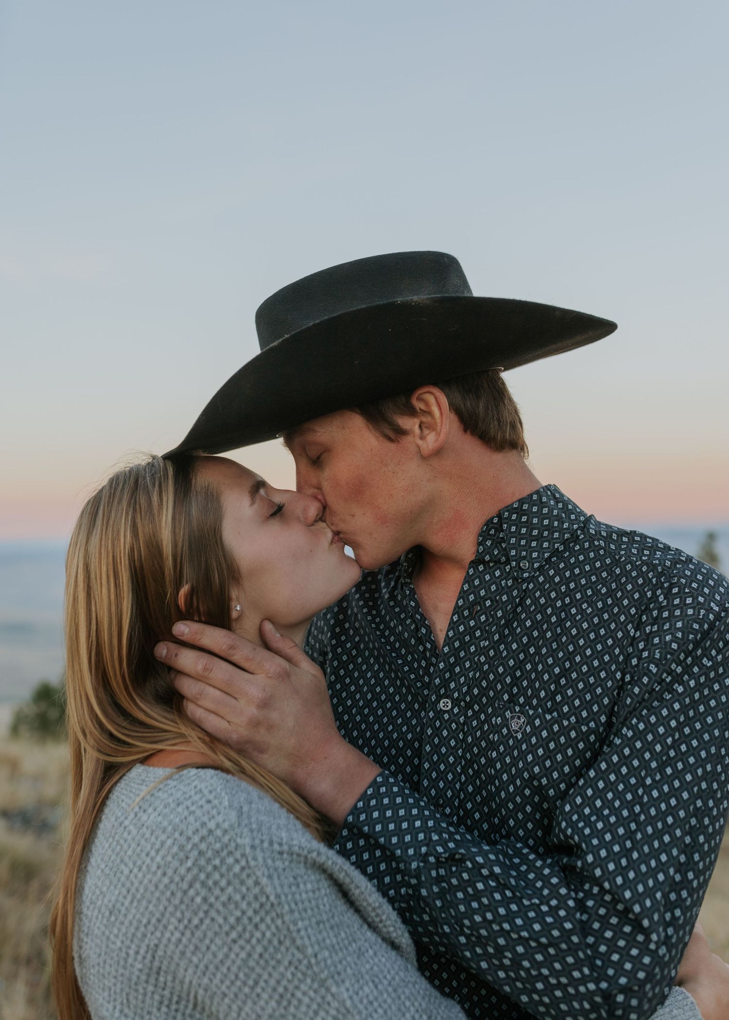 Intimate sunset portrait series of couple sharing tender moments with mountain backdrop.