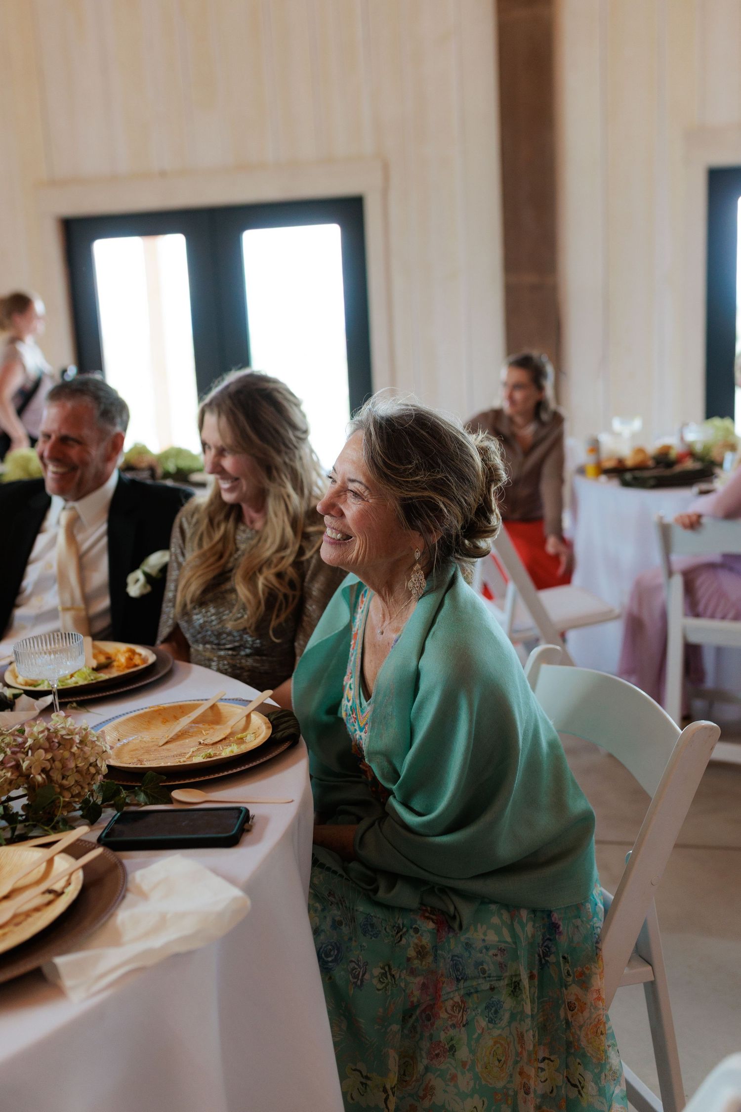 grandma of the groom smiling warmly as she listens to wedding speech in Montana wedding