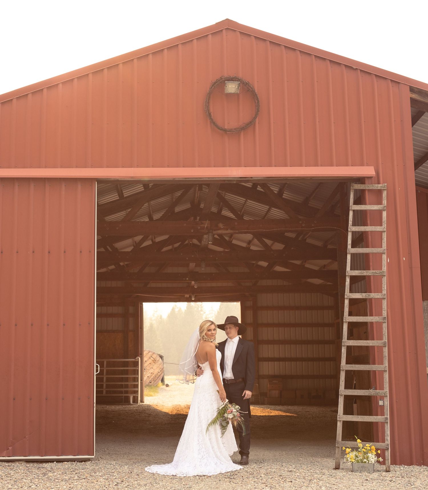 A couple poses in front of a rustic barn door, creating a romantic wedding photo sequence at golden hour.