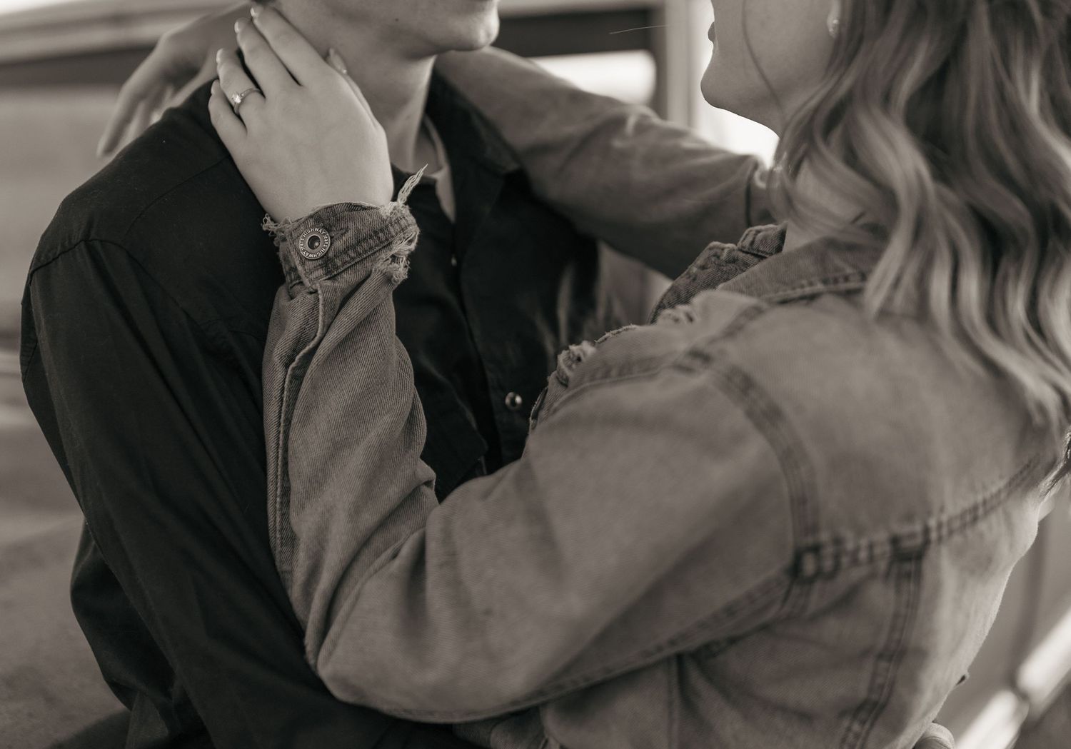 An intimate black and white close-up portrait showing tender emotional connection.