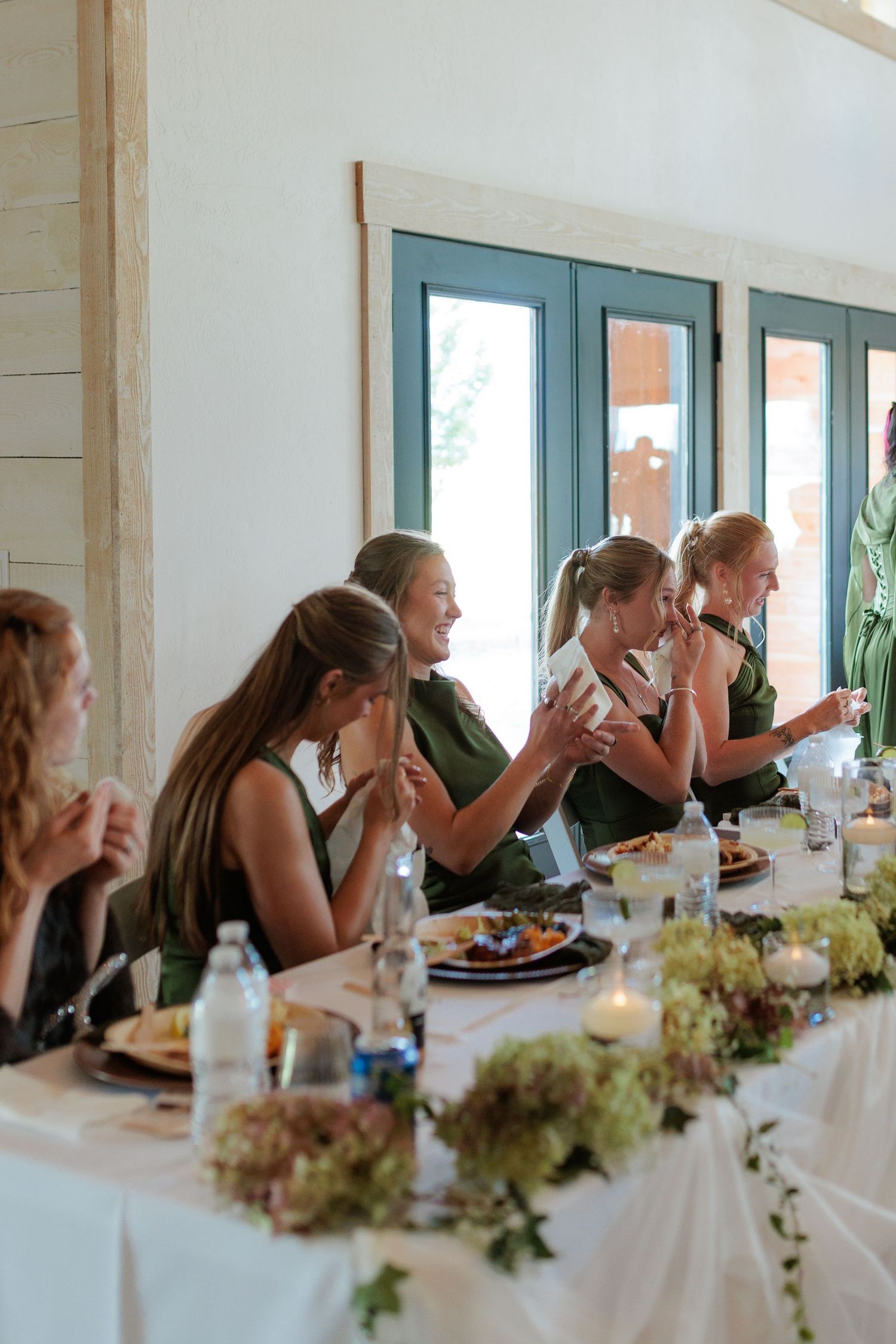 bridesmaids getting emotional listening to wedding speech in Montana wedding