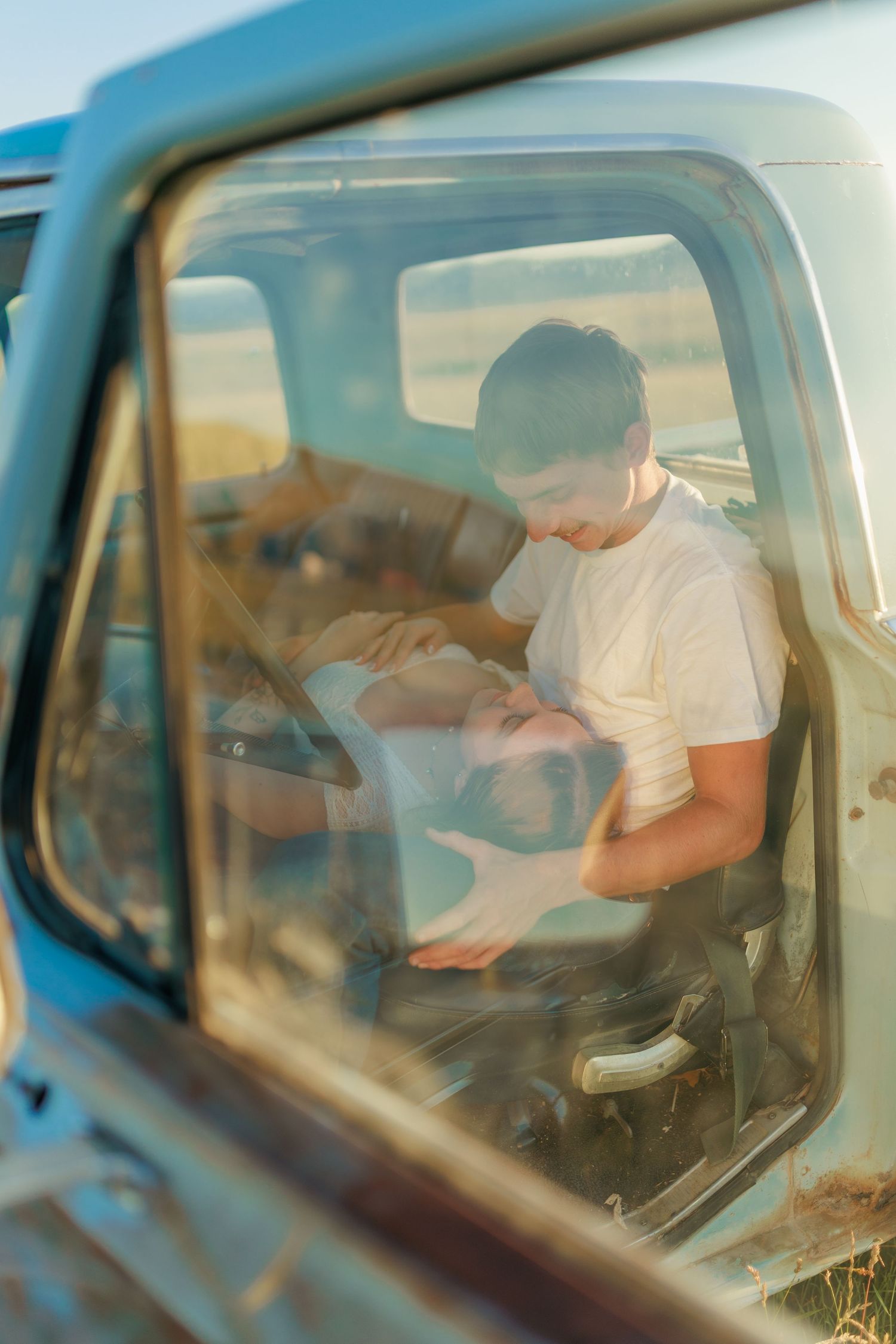 Soft sunlit view through truck window showing interior during golden hour.