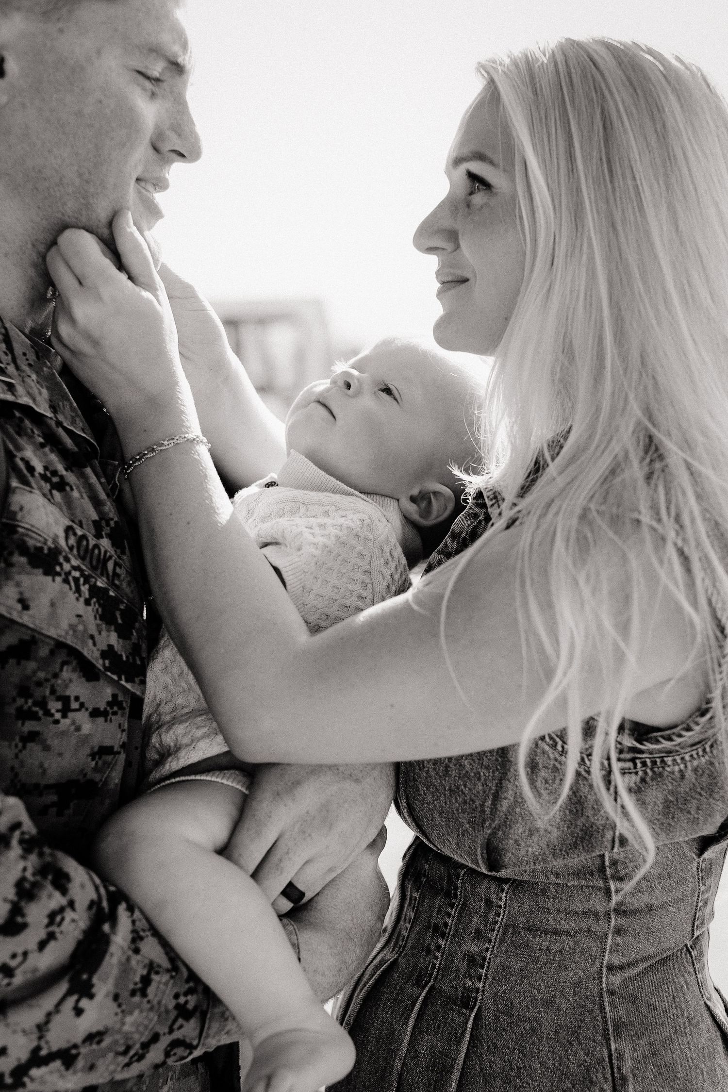 a couple and their baby meet for the first time after a long military deployment