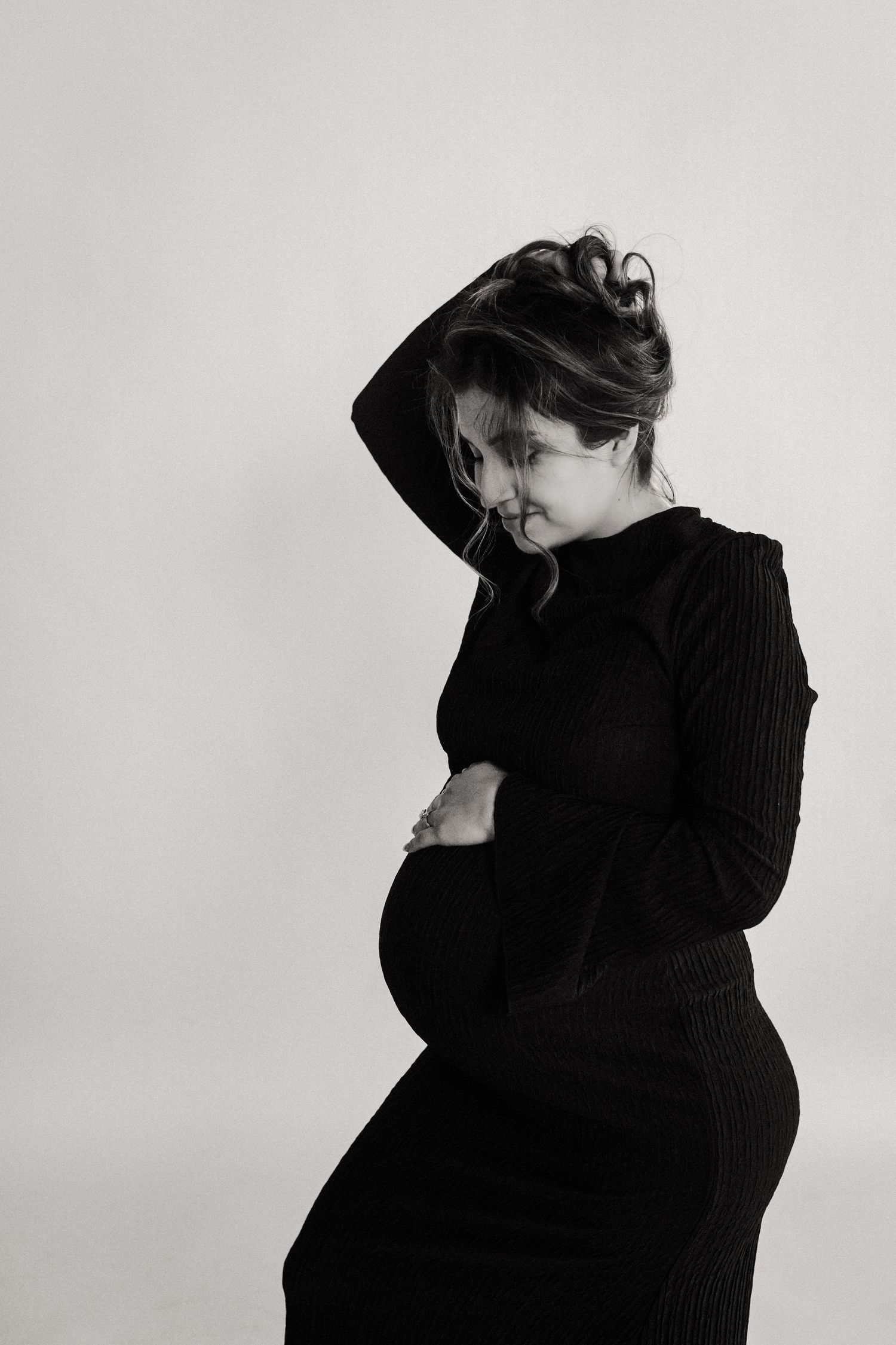 Artistic black and white portrait series showing figure in dark clothing moving against light background.