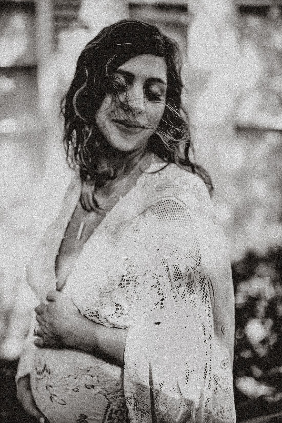 Artistic black and white portrait featuring delicate lace clothing details.
