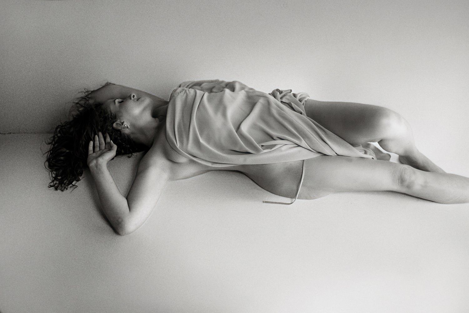 Minimalist black and white reclining figure study.