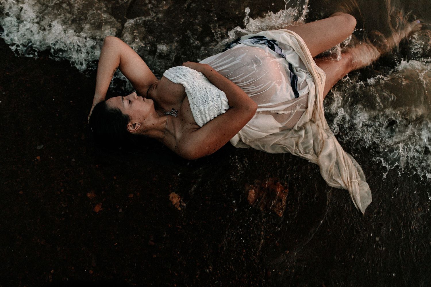 Dramatic black and white photo sequence showing figure reclining in natural outdoor setting.