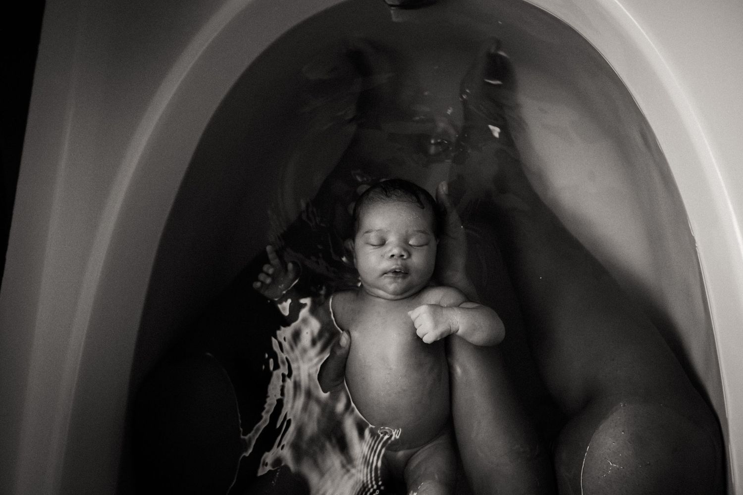 Series of artistic black and white photographs taken in a bathtub with dramatic lighting.