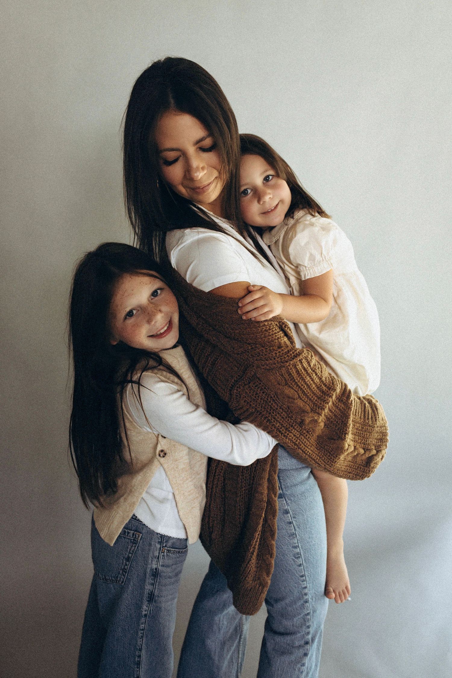 A series of playful photos showing a parent and child in casual clothing sharing joyful moments against a light background.